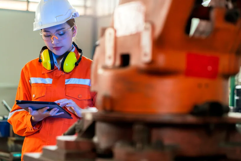 asian female engineer specialist with Measuring machine with a manipulator arm.Three-dimensional coordinate measurement. Check sizes. 3D check of the sizes of parts. CMM after machining process